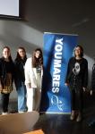 Image showing three panelists and two workshop organisers clustered around YOUMARES conference banner.